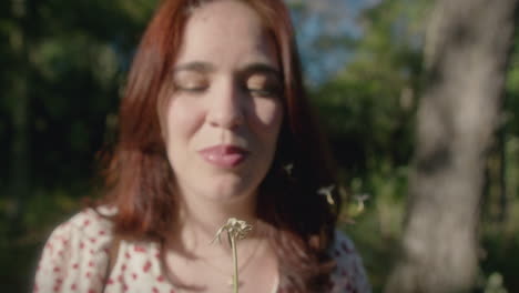 woman blows a dandelion medium shot slow motion