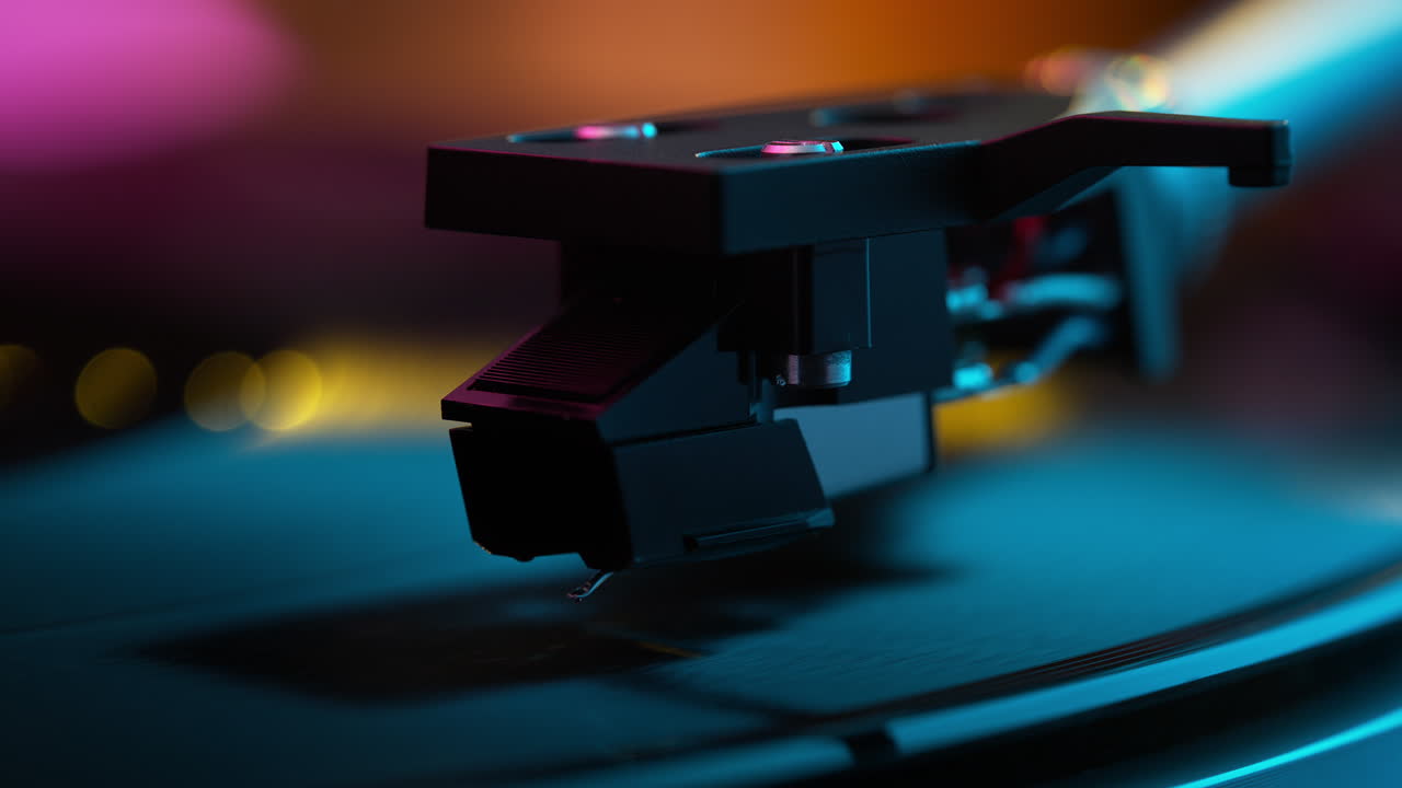Record Player Needle and Cartridge Slightly Lowering onto the Groove of a Spinning Vinyl in Slow Motion - Playing Music at the Party