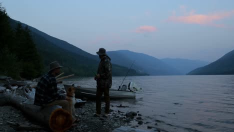 two fishermen interacting with each other near riverside 4k