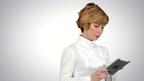 young woman using a tablet on white background