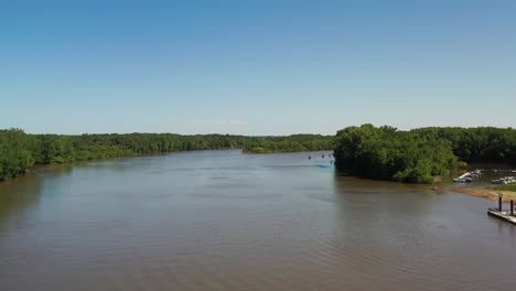 aerial-view-of-a-inlet-with-a-marina-and-trees-surrounding-the-water