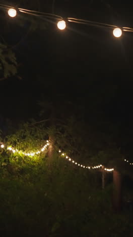 Illuminated with garlands courtyard at night. Country building for tourists to relax among dense forest of untouched nature. Modern accommodation for holiday