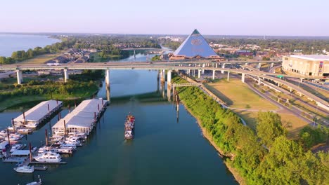 aerial over memphis tennessee waterfront and mud island with memphis pyramid background