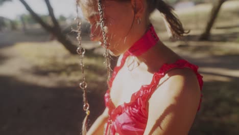 young woman in pink dress outdoors in sunlight