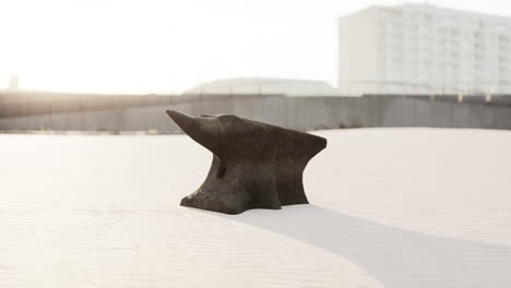 old anvil on a sandy beach