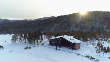 aerial view of a cabin in a snowy forest