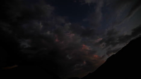 nubes nocturnas naranjas y oscuras en movimiento después de la hora dorada en la naturaleza - lapso de tiempo de abajo hacia arriba