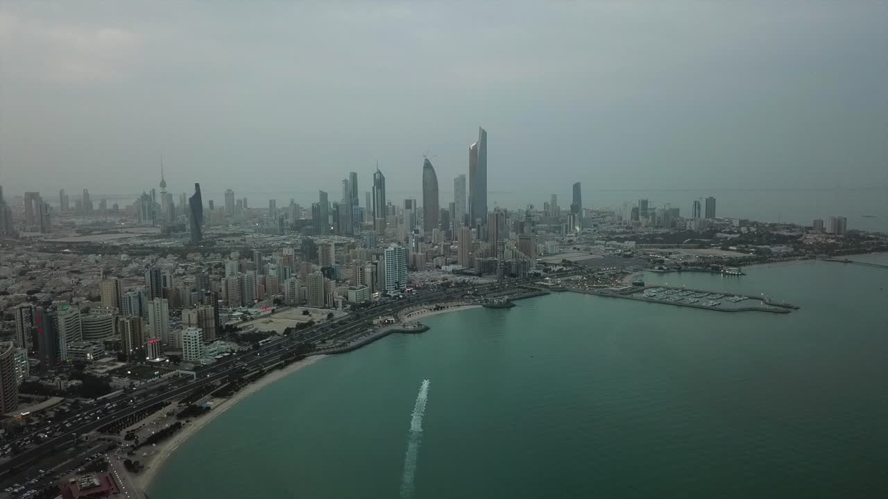 Wide panoramic view of Kuwait City facing the Arabian - Persian Gulf at dusk