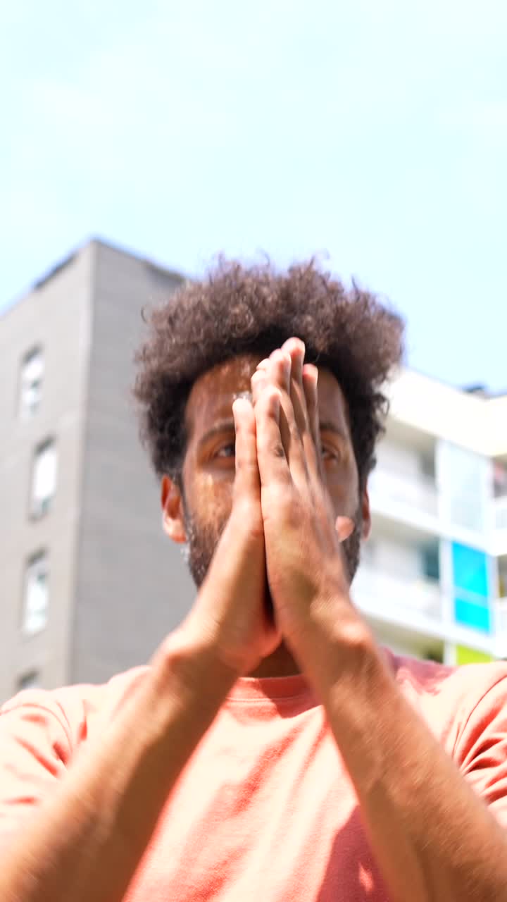 Man with curly hair outdoors