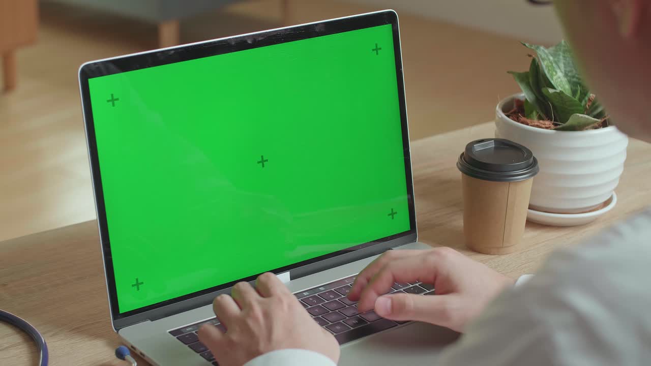 Close Up Male Doctor Typing On Laptop Computer With Green Screen Display , Video In 4K