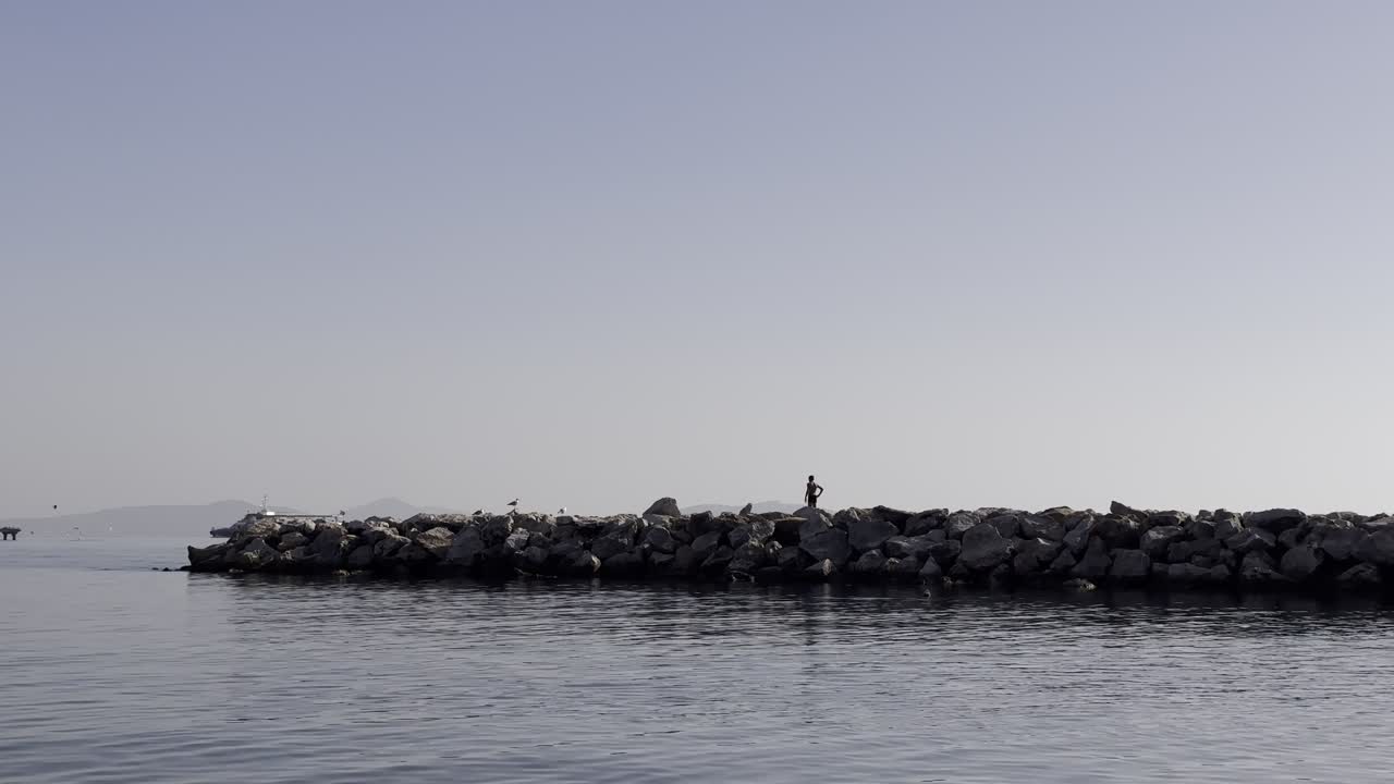 child running and playing on the pier in the sea