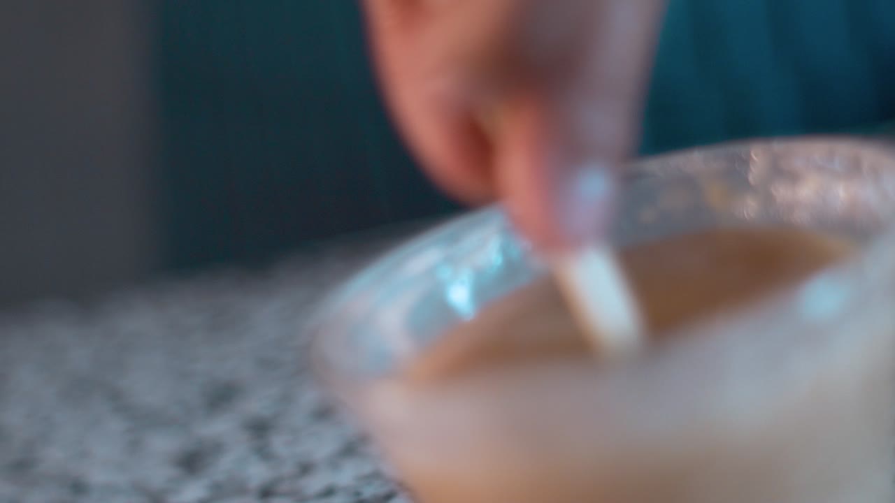 Glacing cake pop with white chocolate in slow mo
