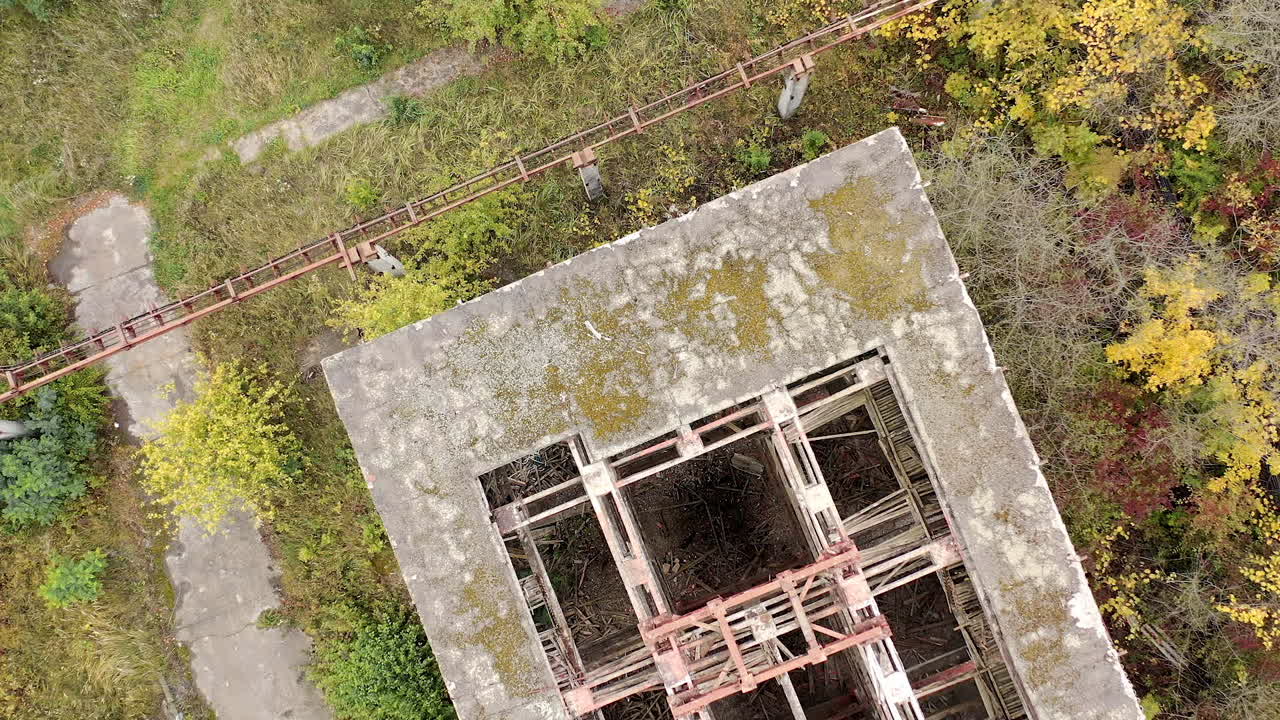 Destroyed building with holes in roof. Old abandoned building of industrial plant. Ruined warehouse. Top view.