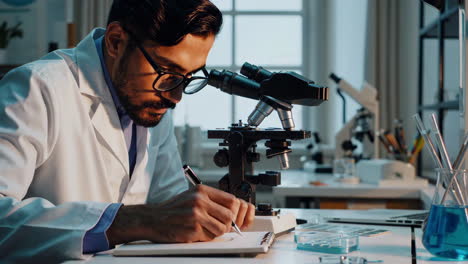 scientist working in a laboratory with a microscope