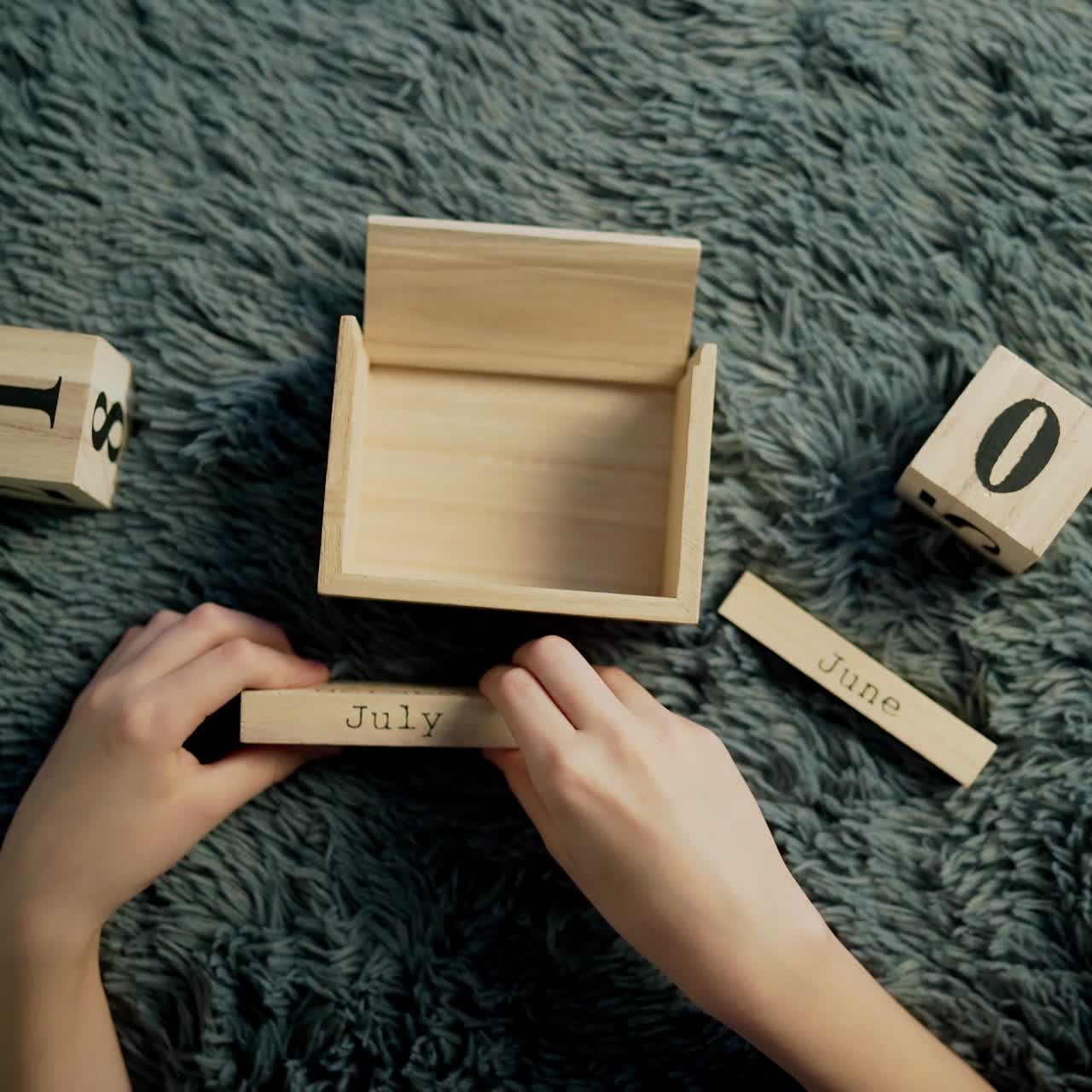 American Independence Day calendar blocks. Boy play with wooden block calendar.