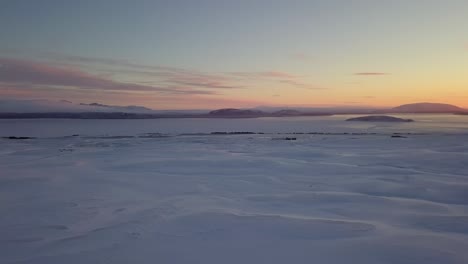 aerial panning view of snow near the icelandic coastline