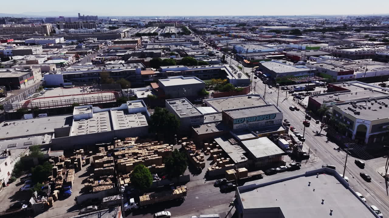 Aerial View of Urban Industrial Area with Stacked Wood and Graffiti