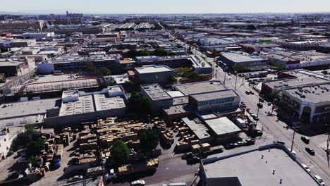 aerial view of urban industrial area with stacked wood and graffiti