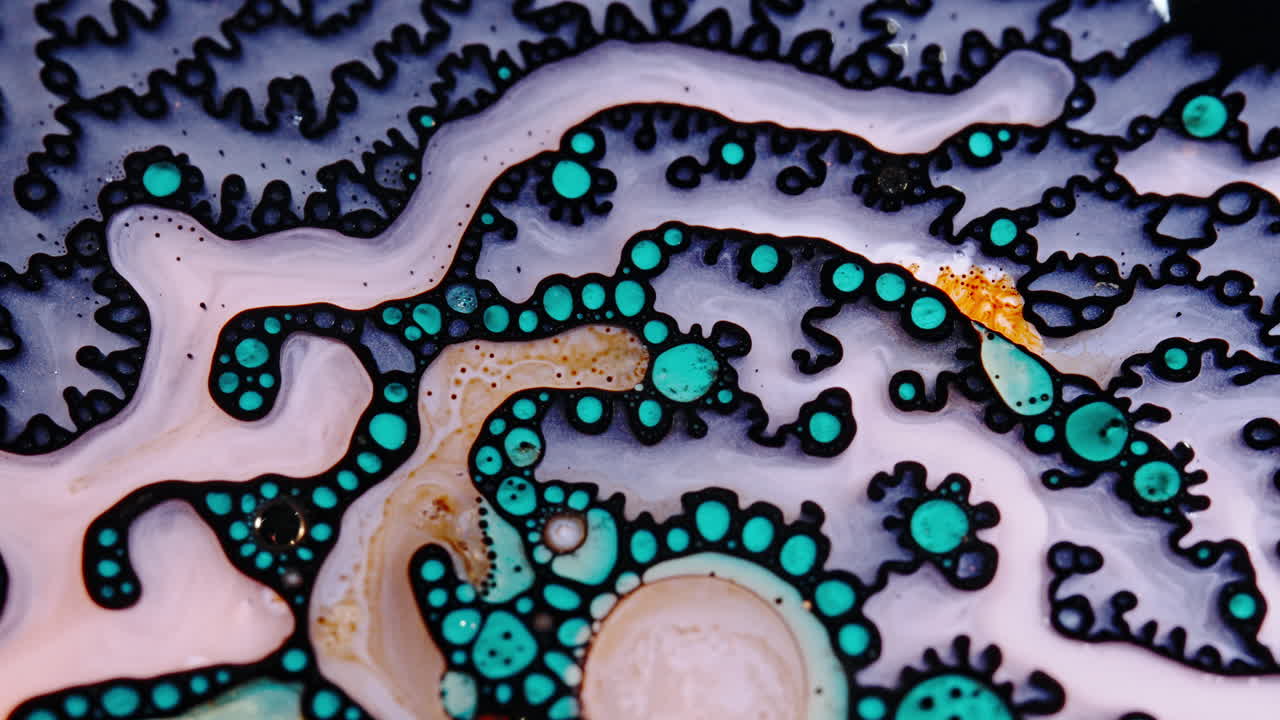 Abstract macro shot of colorful liquid patterns with swirling textures and vibrant bubbles