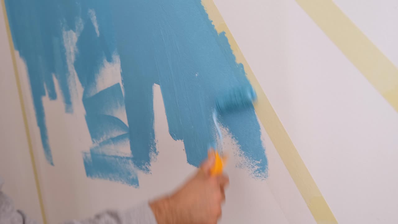 Painting a wall with blue paint