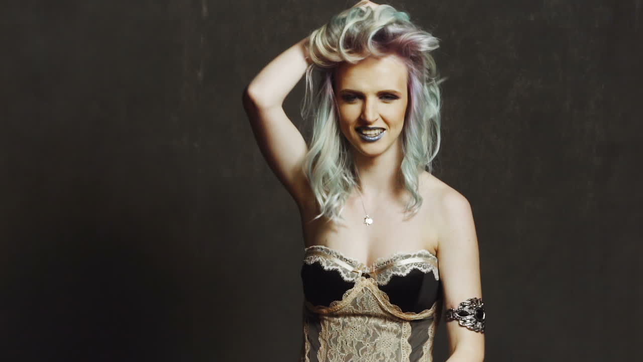 Playful woman in studio. Playful beautiful woman in black studio, portrait