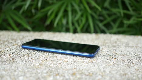 blue smartphone on gravel