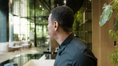 Side-view-of-african-american-receptionist-in-a-hotel