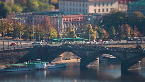 cars, trams, busses rush along the vltava river embankment