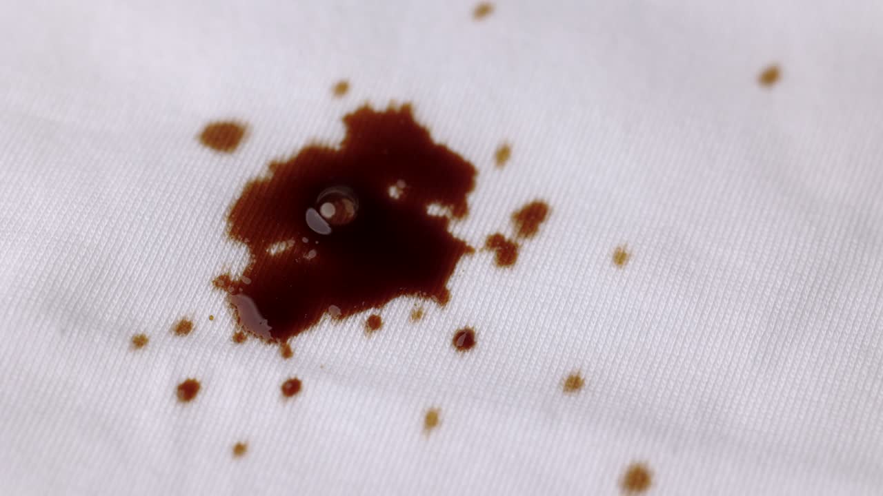 Coffee drop on the shirt. A white cotton shirt stained with brown coffee