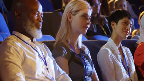 business people sitting on seats in auditorium 4k