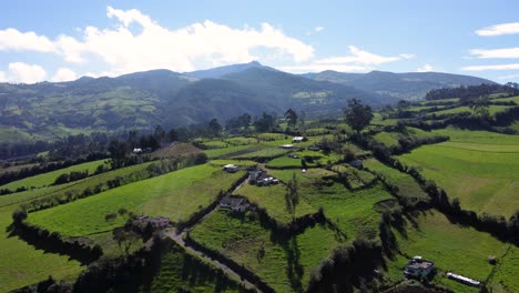 aerial drone flight over a guitig neighborhood in the province of pichincha on a sunny day with clouds over the mountains, slomotion copy space