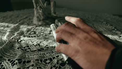 hand hesitates before making call on corded push button telephone slide shot