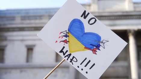 London stands with Ukraine, blue and yellow protester sign in Trafalgar Square in London during protest against war with Russia