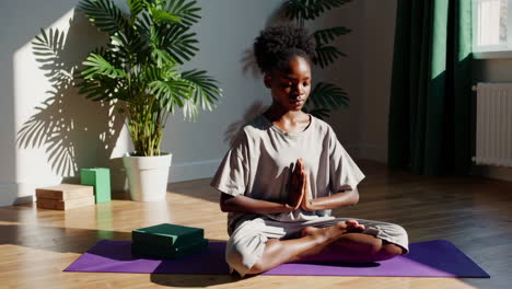 young woman meditating in a serene sunlit room