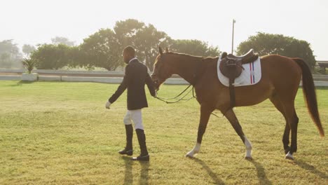 african american man walking with his dressage horse