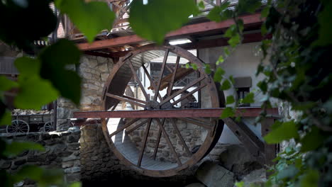 old watermill wheel on display in a renovated antique cottage,zooming