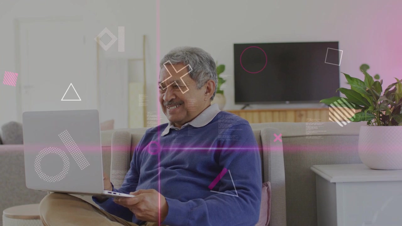 Senior man watching laptop at home, pink overlay sweeping across screen driving tech focus, smiling