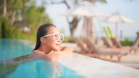 A-pretty-young-woman-fresh-from-swimming-rests-her-chin-on-her-hands