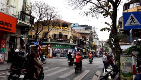 motorbikes and cars on bustling hanoi street