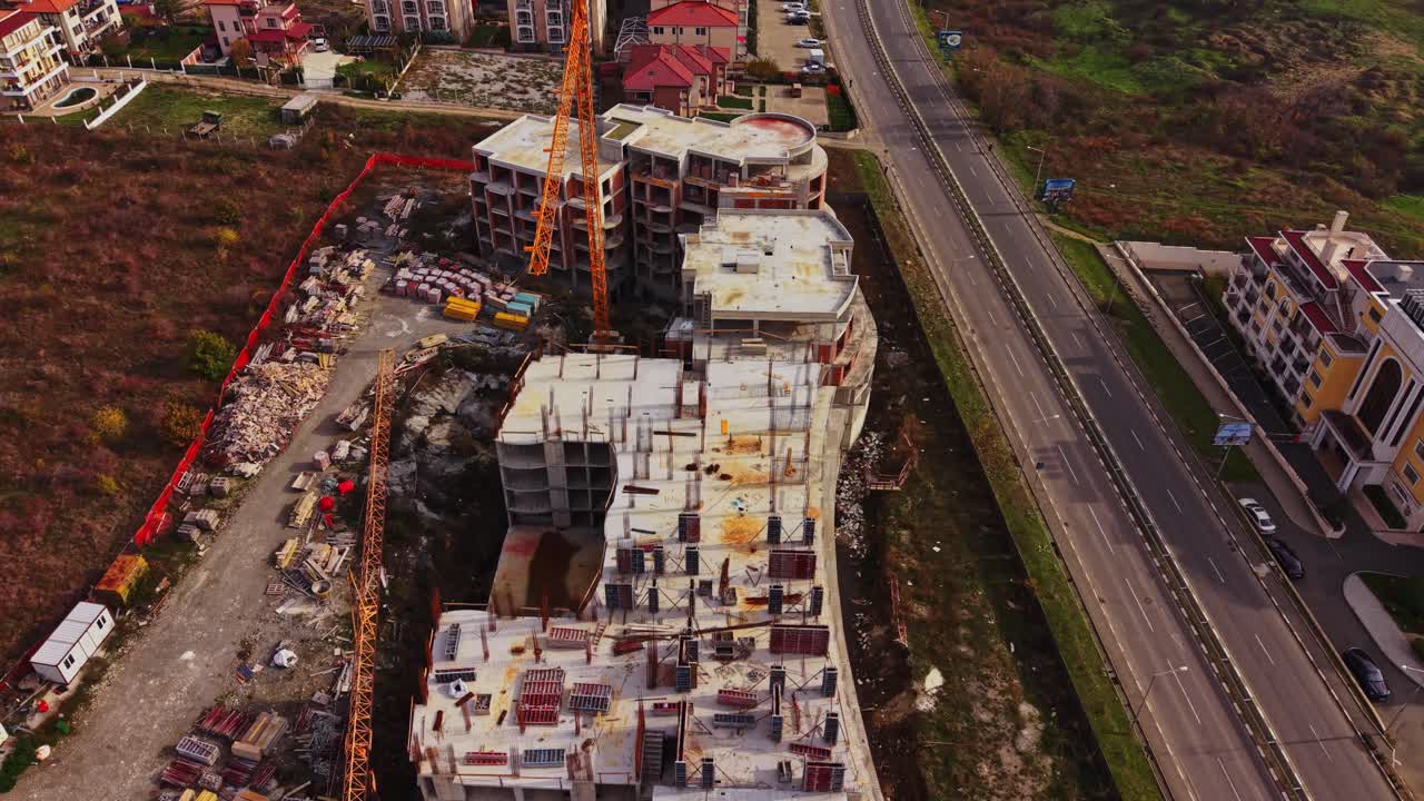 Construction site of a new building complex near a busy road
