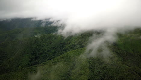 Logistic-concept-aerial-view-of-countryside-road-passing-through-the-serene-lush-greenery-and-foliage-tropical-rain-forest-mountain-landscape