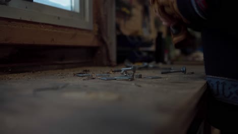 a man's hands gathering and stacking bolts and nuts in indre fosen, trondelag county, norway - close up