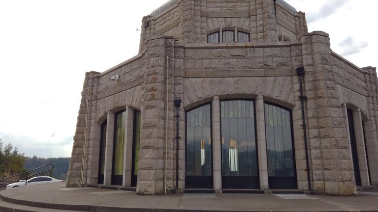 4K Circling counter clockwise around the Vista House on Historic Columbia River Highway with mostly cloudy sky take one