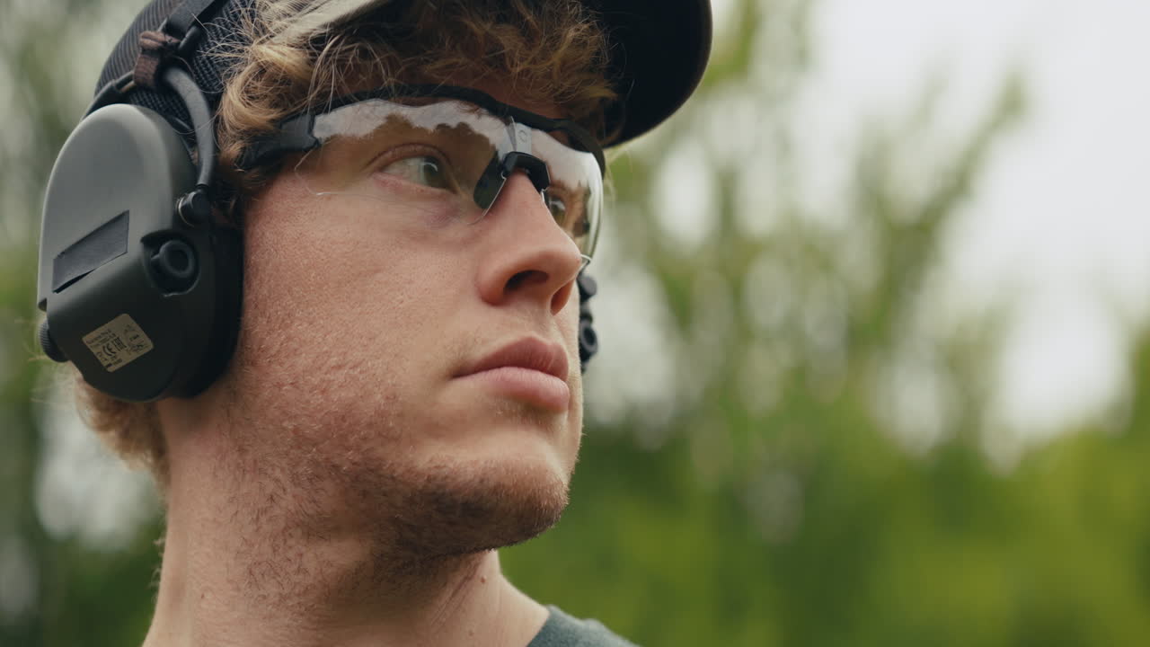 A man wearing ear protection and safety glasses