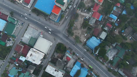 Top-down-dolley-drone-shot-of-traffic-driving-over-the-highway-in-Central-Mandalay-in-Myanmar