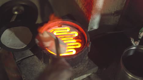 Making-Chappati-or-Indian-bread-on-a-gas-heater-inside-kitchen-of-an-Indian-Dhaba-or-Restaurant