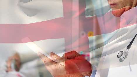 animation of flag of england over caucasian male doctor in hospital