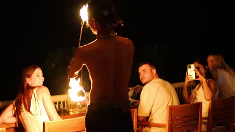 fire performer entertains guests at night