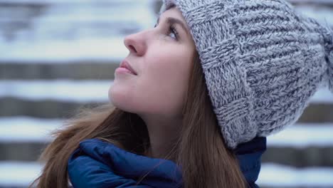 woman in winter hat looking up