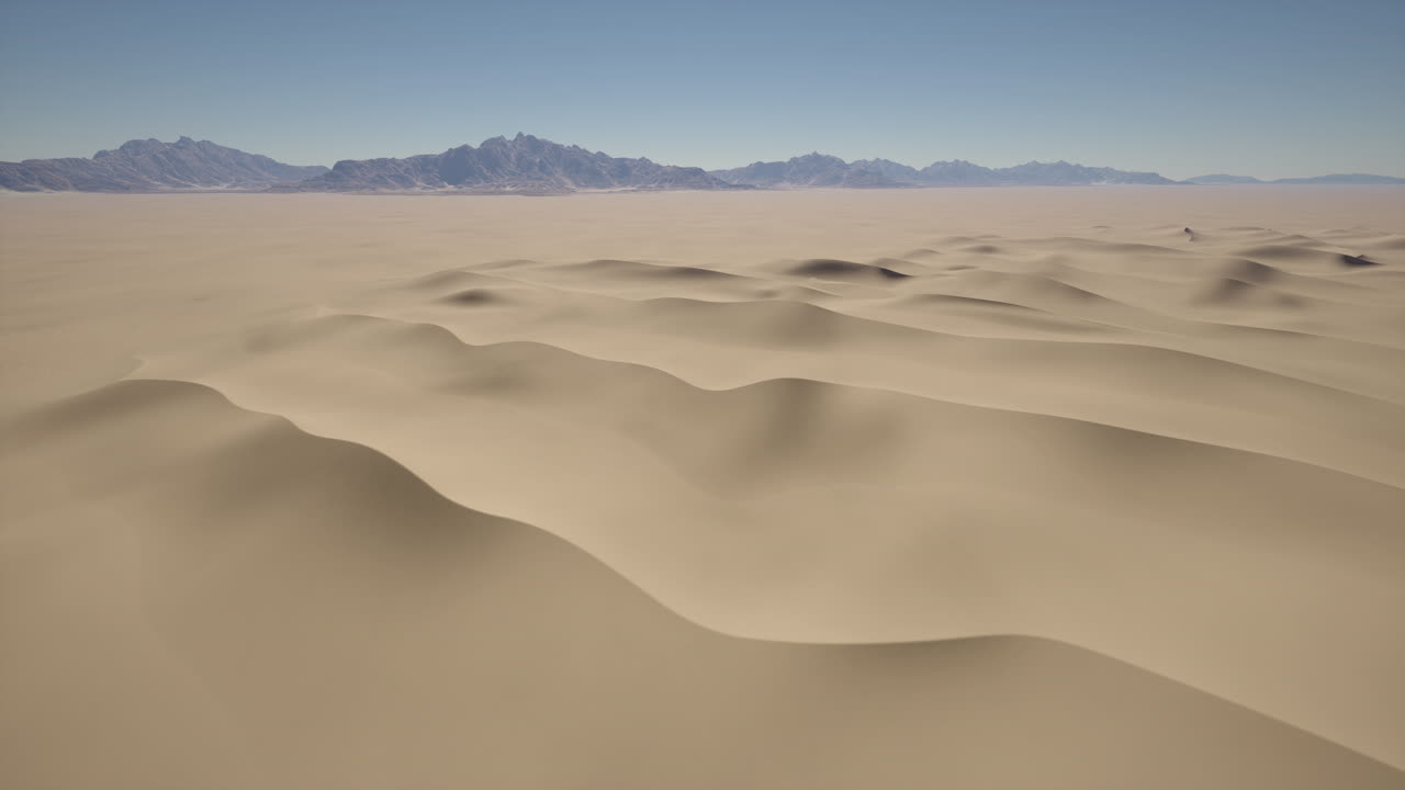 먼 곳 에 산맥 이 있는 사막 의 모래 언덕 의 공중 사진